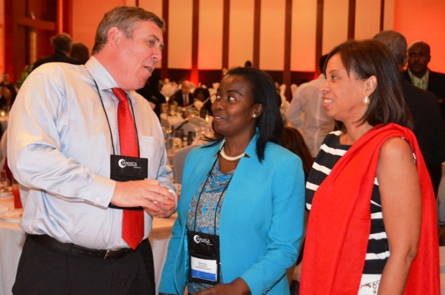 State Minister for Industry, Investment, and Commerce, Hon. Sharon Ffolkes Abrahams (right); and Vice President, Operations and Customer Relations, Montego Bay Free Zone Company Limited, Gloria Henry (centre), are engaged in conversation by Digicel Jamaica's Chief Executive Officer, Barry O'Brien, during the recent two-day Jamaica Investment Forum (JIF), at the Montego Bay Convention Centre in St. James.