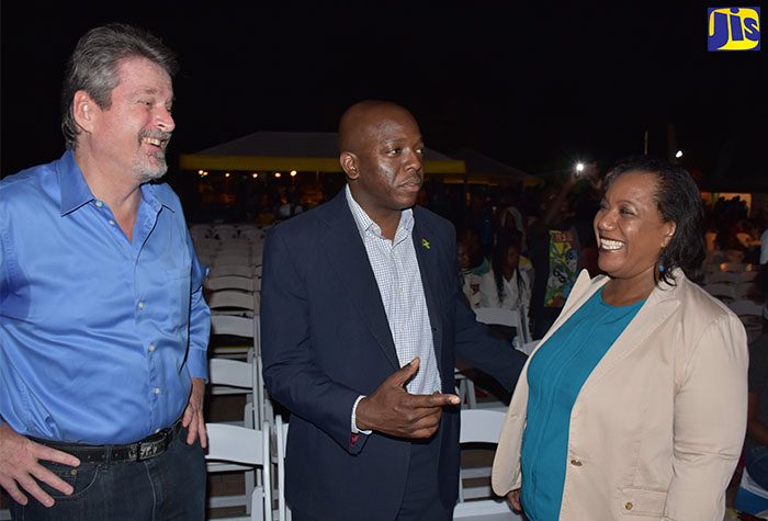 State Minister for National Security, Senator the Hon. Pearnel Charles Jr. (centre), converses with Child Development Agency (CDA) Chief Executive Officer, Rosalee Gage-Grey (right), during the CDA’s 11th annual candlelight vigil and concert at Emancipation Park in New Kingston on Saturday, November 19. The event is the CDA’s main activity to mark World Day for the Prevention of Child Abuse, which is commemorated annually on November 19. Looking on is United Nations Children’s Fund (UNICEF) Representative in Jamaica, Mark Connolly.