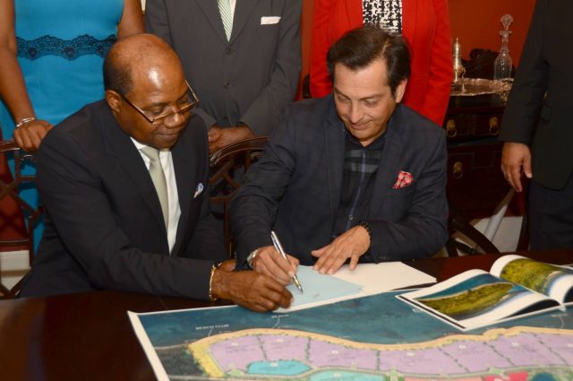 Minister of Tourism, Hon. Edmund Bartlett (Left), signs contract with Karisma Hotel and Resorts' Vice-President of Corporate Affairs & Business Development, Ruben Becerra (Right) on June 14 at Devon House.