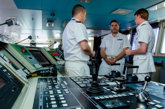 Commanding Officer of Royal Fleet Auxiliary (RFA) Lyme Bay, Captain Paul Minter (centre), in discussion with Assistant to the British Defense Advisor, Chief Petty Officer Allan Hurley (left), and Media Officer, Lt. Max Cosby, during a media tour of the British naval vessel, which is docked at the Kingston Wharves.