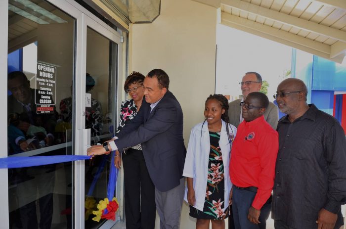 Minister of Health, Hon. Dr. Christopher Tufton (2nd left), cuts the ribbon to officially open the upgraded Drug Serv Pharmacy in Greater Portmore, St. Catherine on June 9. Looking on (from left, forefront)) are: Parish Manager, St. Catherine Health Services, Beverly Needham; Acting Pharmacy Manager, Tina Page; Chief Executive Officer, National Health Fund (NHF), Everton Anderson; and Member of Parliament for South St. Catherine, Fitz Jackson. In the background is Chairman of the NHF, Gregory Mair.