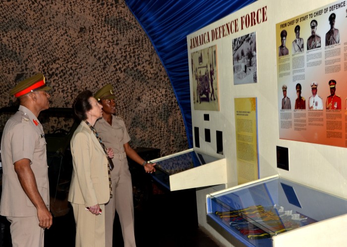Her Royal Highness, the Princess Royal, Princess Anne, is given a history of the Jamaica Defence Force (JDF) by Curator of the Military Museum, Stacey Duhaney (right), while Chief of Defence Staff, Major General Antony Anderson, looks on. Her Royal Highness toured Up Park Camp on October 1, as part of her three-day visit to the island from September 30 to October 2.