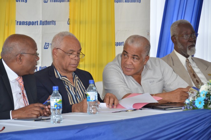 Transport, Works and Housing Minister, Dr. the Hon. Omar Davies (2nd left), peruses a document, while Minister without Portfolio, Ministry of Transport, Works and Housing, Hon. Dr. Morais Guy (left), engages Water, Land, Environment and Climate Change Minister, Hon. Robert Pickersgill (2nd right), during Wednesday’s (February 3) official opening ceremony for the new Linstead Transportation Centre, in St. Catherine. Mr. Pickkersgill is the Member of Parliament for the area. At right is Custos Rotulorum for St. Catherine, Hon. Rev. Jeffrey McKenzie.