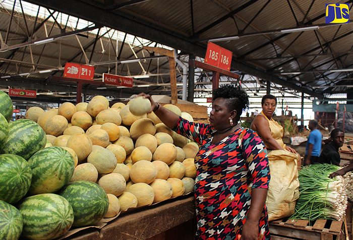 Nicola Reid attends to her merchandise inside the Coronation Market, downtown Kingston