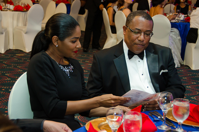 Minister of Industry, Investment and Commerce, Hon. Anthony Hylton (right), and Minister of Youth and Culture, Hon. Lisa Hanna, share a programme at Burger King's 30th anniversary awards ceremony, held at the Pegasus Hotel on Monday, October 27.