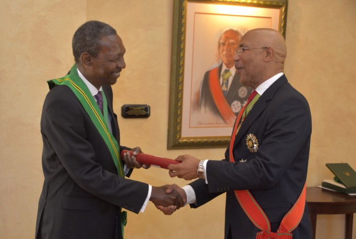 Governor-General, His Excellency the Most Hon. Sir Patrick Allen (right), presents newly appointed President of the Court of Appeal, Justice Cecil Dennis Morrison, with the fifth highest National Honour, the Order of Jamaica, at a swearing-in ceremony, held  at King’s House on January 4. 