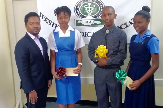 Chairman of the Western Medical Association (WMA), Dr. Garfield Badal (left), with recipients of the 2015 WMA Grade Six Achievement Test (GSAT) award, at a ceremony held on January 24. From second left are:  Jessica McKnight,  Antonio Colman and Candice Owens.