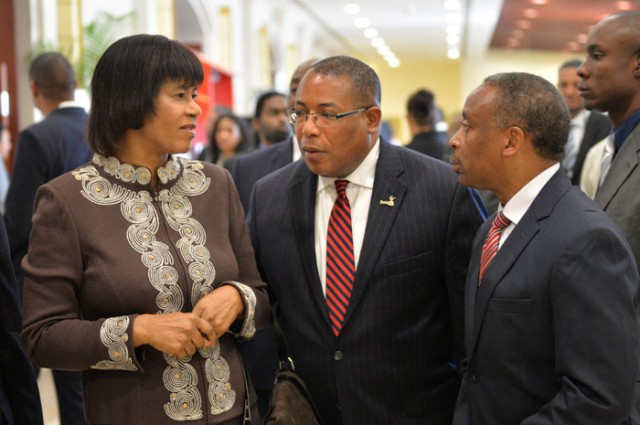 Prime Minister, the Most Hon. Portia Simpson Miller (left), is in conversation with Minister of Industry, Investment and Commerce, Hon. Anthony Hylton (centre) and Chairman of Jamaica Promotions Limited (JAMPRO), Milton Samuda, at the 2nd Jamaica Investment Forum on March 11 at the Montego Bay Convention Centre in St. James.
