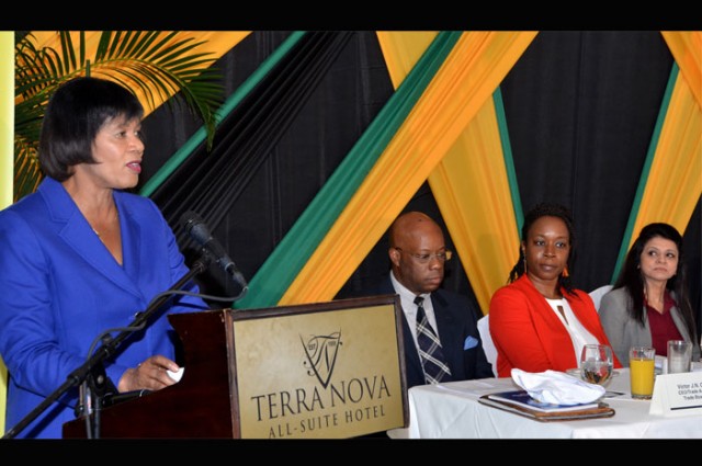 Prime Minister Portia Simpson Miller (left) speaking at the launch of the National Export Strategy, Phase II at the Terra Nova Hotel in Kingston on Thursday August 20. Listening intently are from left, Trade Administrator/CEO of the Trade Board, Mr. Victor Cummings; Advisor (Trade Competitiveness) Trade Division Commonwealth Secretariat Ms. Yinka Bandele; and Dr. Rashmi Banga, Adviser and Head of Trade Competitiveness Section, Commonwealth Secretariat.