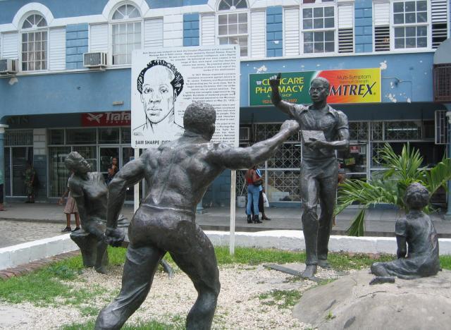 The Sam Sharpe Monument, designed by Kay Sullivan, portrays Sharpe holding his Bible and speaking to his people. The five statues were cast in bronze in Jamaica. 