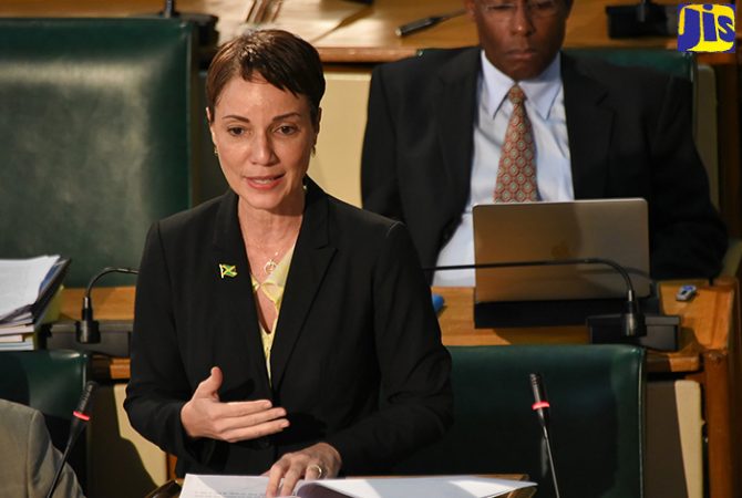 Minister of Foreign Affairs and Foreign Trade, and Leader of Government Business in the Upper House, Senator the Hon. Kamina Johnson Smith, pilots the Trafficking in Persons (Prevention, Suppression and Punishment) (Amendment) Act, 2018; and companion Bill, the Child Care and Protection (Amendment) Act, 2018, in the Senate on Friday (February 23). Also pictured in the background, is Deputy President of the Senate, Senator Aubyn Hill.