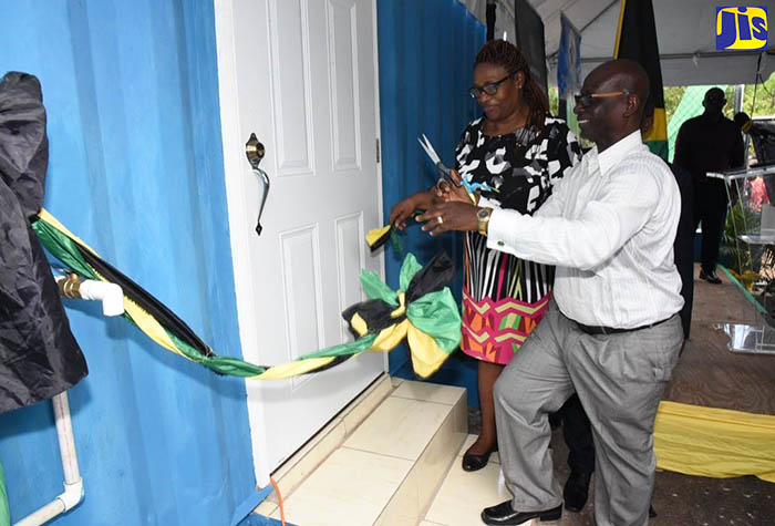Local Government and Community Development Minister,  Hon.  Desmond McKenzie (right), and Councillor for the Grove Town Division, Iceval Brown, cut the ribbon to officially open the water shop in Marlie Hill, Manchester, on Monday, May 14.