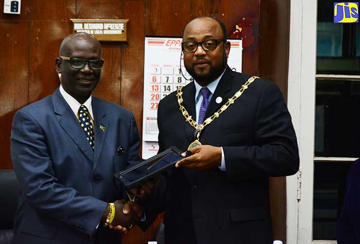 Minister of Local Government and Community Development, Hon. Desmond McKenzie (left), receives a gift from His Worship, the Mayor of St. Ann’s Bay, Councillor Michael Belnavis (right), at a special meeting of the St. Ann Municipal Corporation in St. Ann’s Bay on May 10.