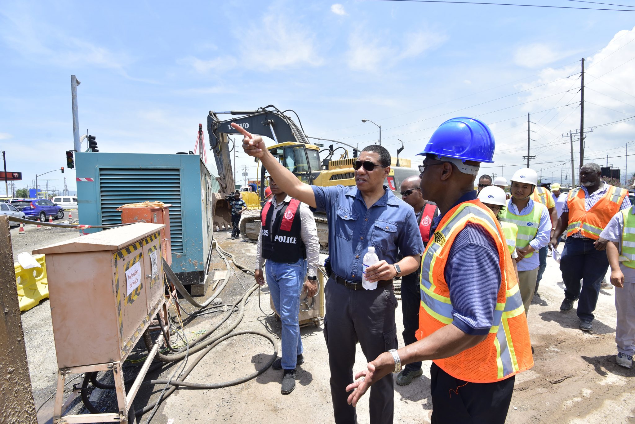 Prime Minister, the Most Hon. Andrew Holness (left, foreground), makes a point to Chief Executive Officer, National Works Agency, E.G. Hunter, about a matter concerning improvement works being done on Hagley Park Road in St. Andrew, during a tour of the project on Friday (June 1). Hagley Park Road Improvement Project was among several legacy projects, being developed in the Corporate Area under the Major Infrastructure Development Programme, which Mr. Holness toured.
