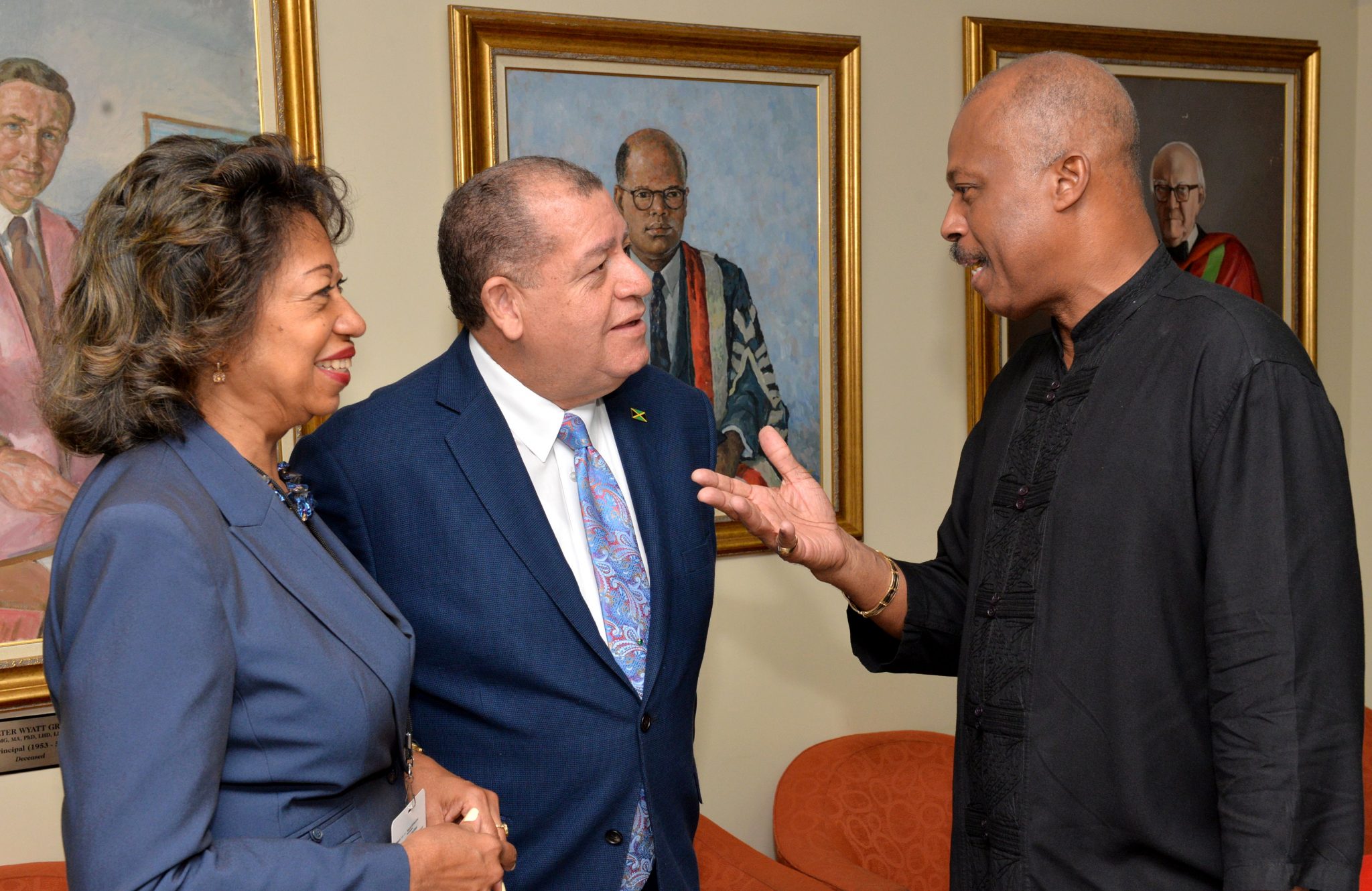 Industry, Commerce, Agriculture and Fisheries Minister, Hon. Audley Shaw (centre), listens attentively to Vice-Chancellor of the University of the West Indie, Sir Hilary Beckles (right), at the opening of a two-day conference on arbitration hosted by the Jamaica International Arbitration Centre (JAIAC) Limited, at the Regional Headquarters of the University of the West Indies in Mona on June 28. At left is President of Jamaica Promotions Corporation (JAMPRO), Diane Edwards.