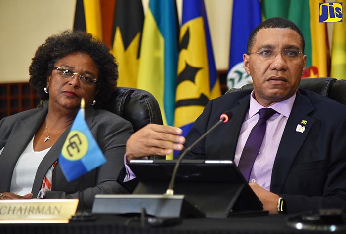 Prime Minister, the Most Hon Andrew Holness (right), responds to questions from journalists during a press conference on Friday (July 6), following the 39th Regular Meeting of the Conference of Heads of Government of the Caribbean Community (CARICOM), which was held at the Montego Bay Convention Centre in St. James from July 4 to 6.  Also pictured is Prime Minister of Barbados, Hon. Mia Mottley. 