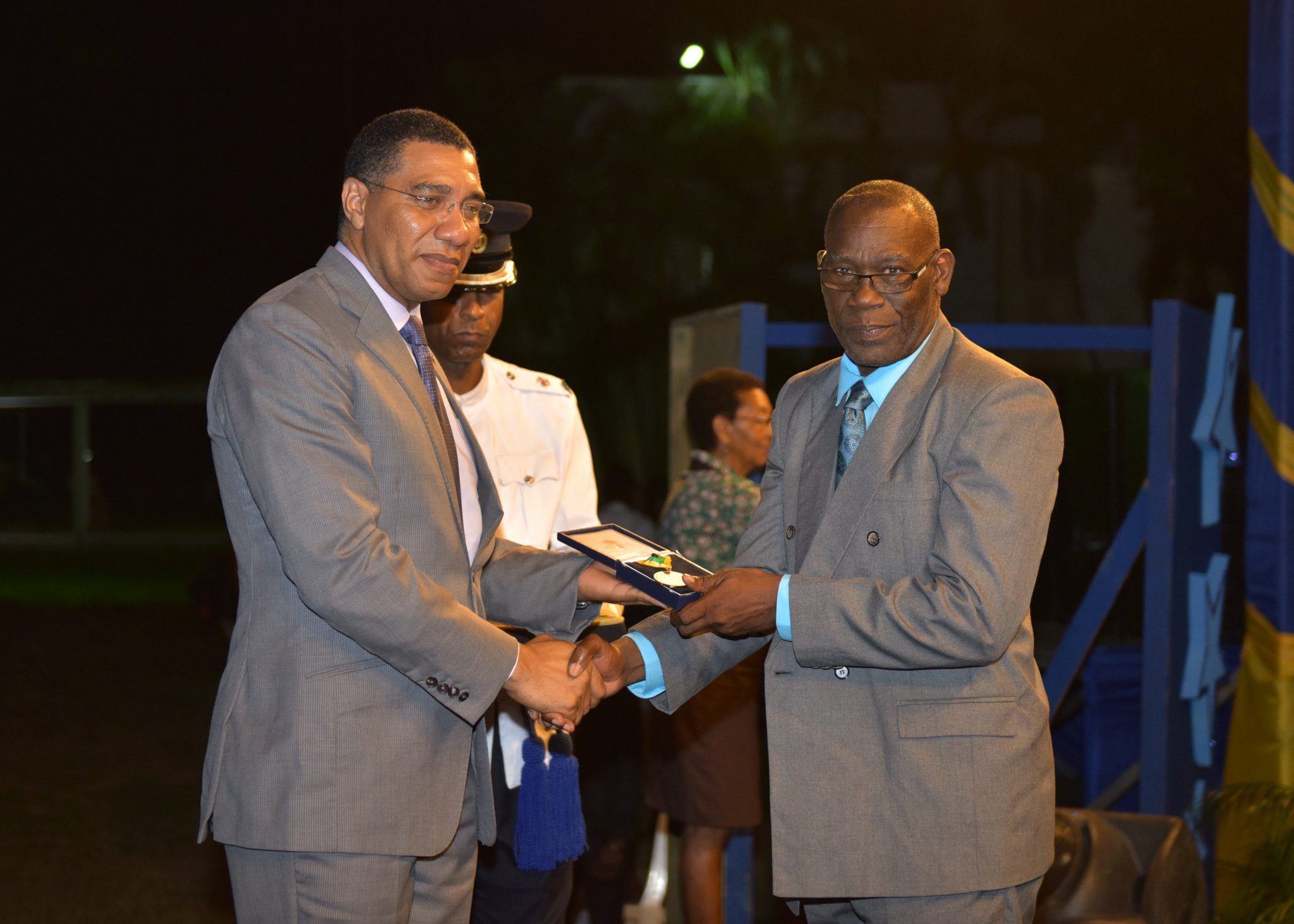 Prime Minister the Most Hon. Andrew Holness, (left) presents Retired Principal of Campbell’s Castle Primary and Infant School, Rev. Owen Lambert (right) with the Prime Minister’s Medal of Appreciation for Service to Education at the awards ceremony held on the lawns of Jamaica House on June 27.