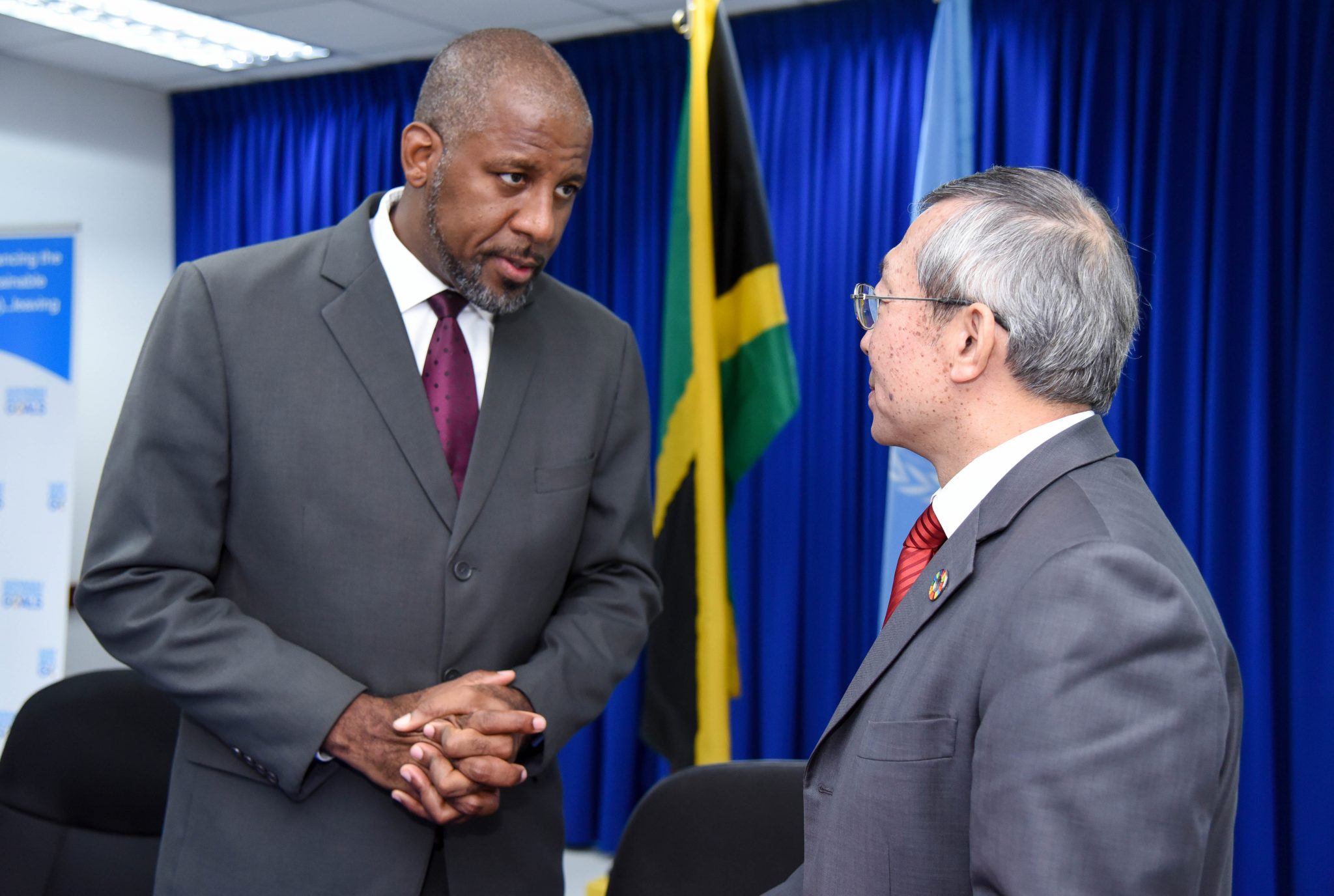 Planning Institute of Jamaica (PIOJ) Director General, Dr. Wayne Henry (left), converses with International Atomic Energy Agency (IAEA) Deputy Director General for Technical Cooperation, Dazhu Yang, during Thursday’s (August 9) signing ceremony for Jamaica’s new five-year IAEA Country Programme Framework (CPF) at the PIOJ’s head office in New Kingston. The new CPF will run from 2018 to 2023.