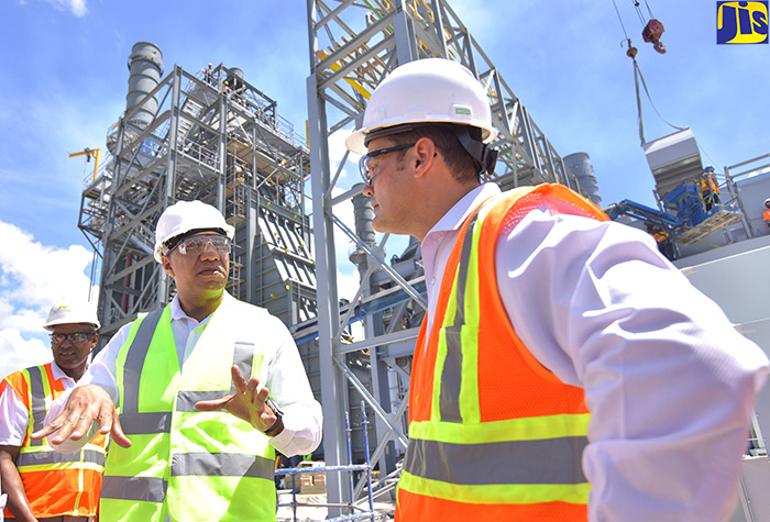 Prime Minister, the Most Hon. Andrew Holness (left), discusses the progress of work for the construction the Jamaica Public Service’s (JPS) 190 megawatt (MW) power plant in Old Harbour Bay, St. Catherine, with JPS President and Chief Executive Officer, Emanuel DaRosa. Mr. Holness was on a tour of the project site on Tuesday (August 21). 