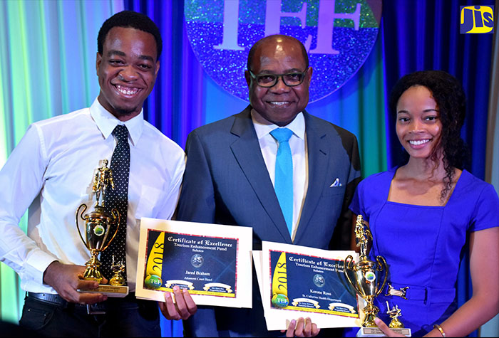 Tourism Minister, Hon. Edmund Bartlett (centre), with the Top Boy of the 2018 Tourism Enhancement Fund (TEF) summer internship, Jared Braham (left) and Top Girl, Kerone Ross, at an awards ceremony hosted by TEF at the Courtleigh Auditorium on August 28.