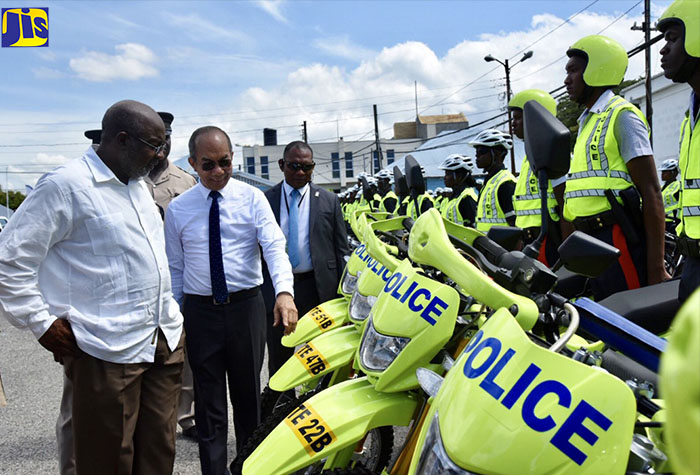 Minister of National Security, Hon. Dr. Horace Chang (second left), examines some of the newly acquired motorbikes that will be used by the just-established Public Safety and Traffic Enforcement Branch of the Jamaica Constabulary Force (JCF).  With the Minister is Opposition Spokesman on National Security, Fitz Jackson. Occasion was a ceremony held at Harman Barracks in Kingston on Wednesday (August 29) to officially launch the branch.

