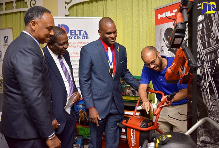 Urban Development Corporation (UDC) Chairman, Senator Ransford Braham (second left), is given a demonstration of equipment by General Manager,  Delta Supply Company Limited,  Jonathan Swire (right), during a tour of booths, following the opening ceremony for the Jamaica Institution of Engineers (JIE) Engineers’ Week 2018 at The Knutsford Court Hotel, New Kingston, on Monday (September 17). Senator Braham represented Prime Minister the Most Hon. Andrew Holness. Also looking on (from left) are Chairman, Professional Engineers Registration Board, Omar Sweeney; and JIE President, Dwight Ricketts. Engineers’ Week 2018 is being observed from September 16 to 22 under the theme ‘Engineering our Future through Celebrating our Heritage’.