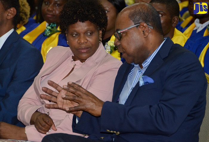 Tourism Minister, Hon. Edmund Bartlett (right), converses with Permanent Secretary in the Ministry of Tourism, Jennifer Griffith (left), at the graduation ceremony for the second cohort of participants to be certified under the Jamaica Centre for Tourism Innovation (JCTI) programme. The ceremony took place at the Montego Bay Convention Centre, Rose Hall, St. James, on Wednesday, October 17.