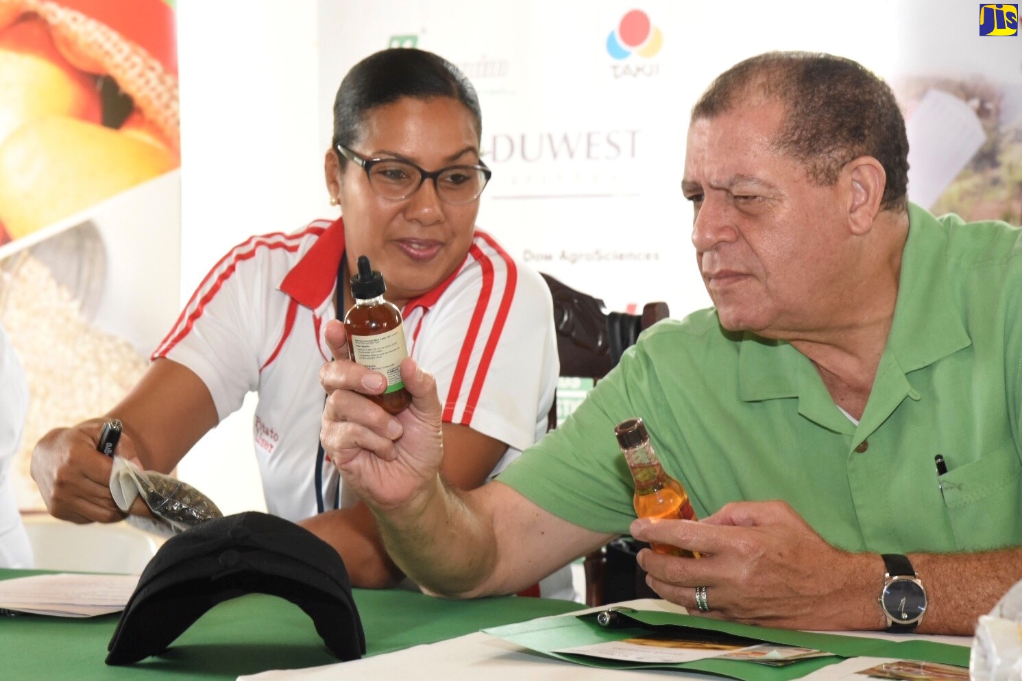 Minister of Industry, Commerce, Agriculture and Fisheries Hon. Audley Shaw looks at a product made by a women's group in Coleyville, Manchester at the launch of the 2018/2019 Irish Potato Programme at Christ Church, Christiana, Manchester on October 4. At right is Business Development Manager, Newport Fersan Jamaica, Hedda Rose Pitter.