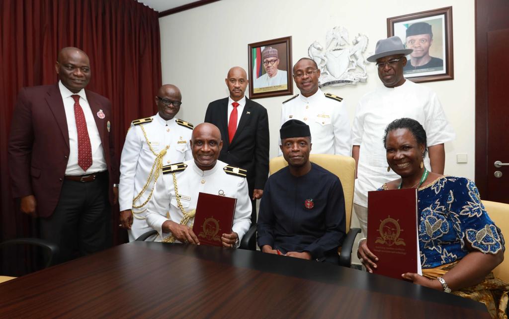 Vice President of Nigeria Mr. Yemi Osinbajo (seated – centre) joins the celebration of the signing of Memoranda of Understanding (MOU) between the Caribbean Maritime University and three Nigerian Universities on Wednesday November 21 at the Nigeria Maritime University. President of the Caribbean Maritime University Professor Fritz Pinnock (seated – left) and Vice Chancellor of the Nigeria Maritime University (NMU) Mrs. O.M. Etebu (seated – right) display their copies of the MOU following the signing of the agreement. The occasion was also used to sign agreements between CMU and University of Lagos (UNILAG) and also Ondo State University of Science and Technology. Also participating in the signing ceremony were (standing from left to right) Vice Chancellor of UNILAG, Professor Ogundipe,  Deputy President of CMU Professor Ibrahim Ajagunna,  Acting High Commissioner of Jamaica, Ambassador John Clarke Doctoral Student of CMU, Mr. Balfour Peart and Pro Chancellor and Chairman of Council at NMU Chief Timipre Sylva.