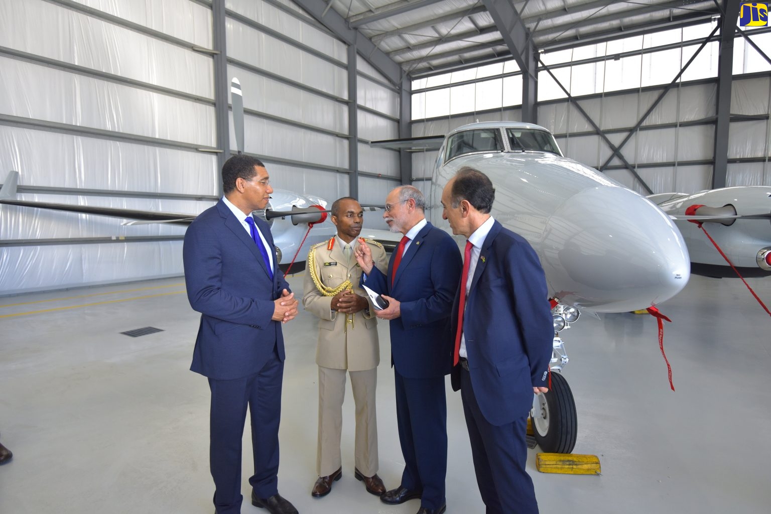 Prime Minister and Minister of Defence, the Most Hon. Andrew Holness (left), listens to a point from United States Deputy Assistant Secretary of Defence for Western Hemisphere Affairs, Sergio de la Pena (second right), following Wednesday’s (November 14) commissioning of the Jamaica Defence Force