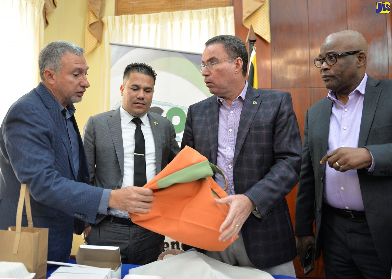 Minister Without Portfolio in the Ministry of Economic Growth and Job Creation, Hon. Daryl Vaz (2nd right), is presented with a reusable tote bag by Jamaica Manufacturers and Exporters Association (JMEA), Metry Seaga, during a recent press conference to provide an update on the ban of single-use plastics and polystyrene (Styrofoam) products at Jamaica House. Looking on are Government Senator, Matthew Samuda (2nd left), and Chief Executive Officer, National Environment and Planning Agency (NEPA) Peter Knight.