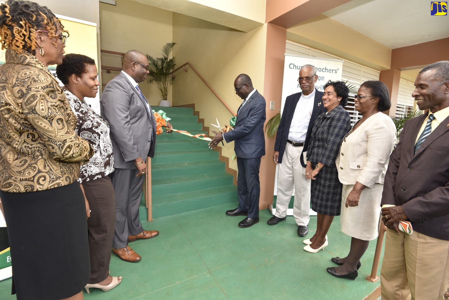 Education, Youth and Information Minister, Senator the Hon. Ruel Reid (fifth right), cuts the ribbon to officially open the Educational Assessment and Resource Centre at the Church Teachers