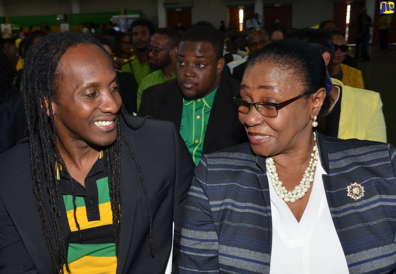 State Minister in the Ministry of Education, Youth and Information, the Hon. Alando Terrelonge (left), speaking with Custos for the Parish of St. Andrew, Hon. Dr. Patricia Dunwell, during the Jamaica Day Civic Ceremony held at the National Arena on Friday (February 22).
