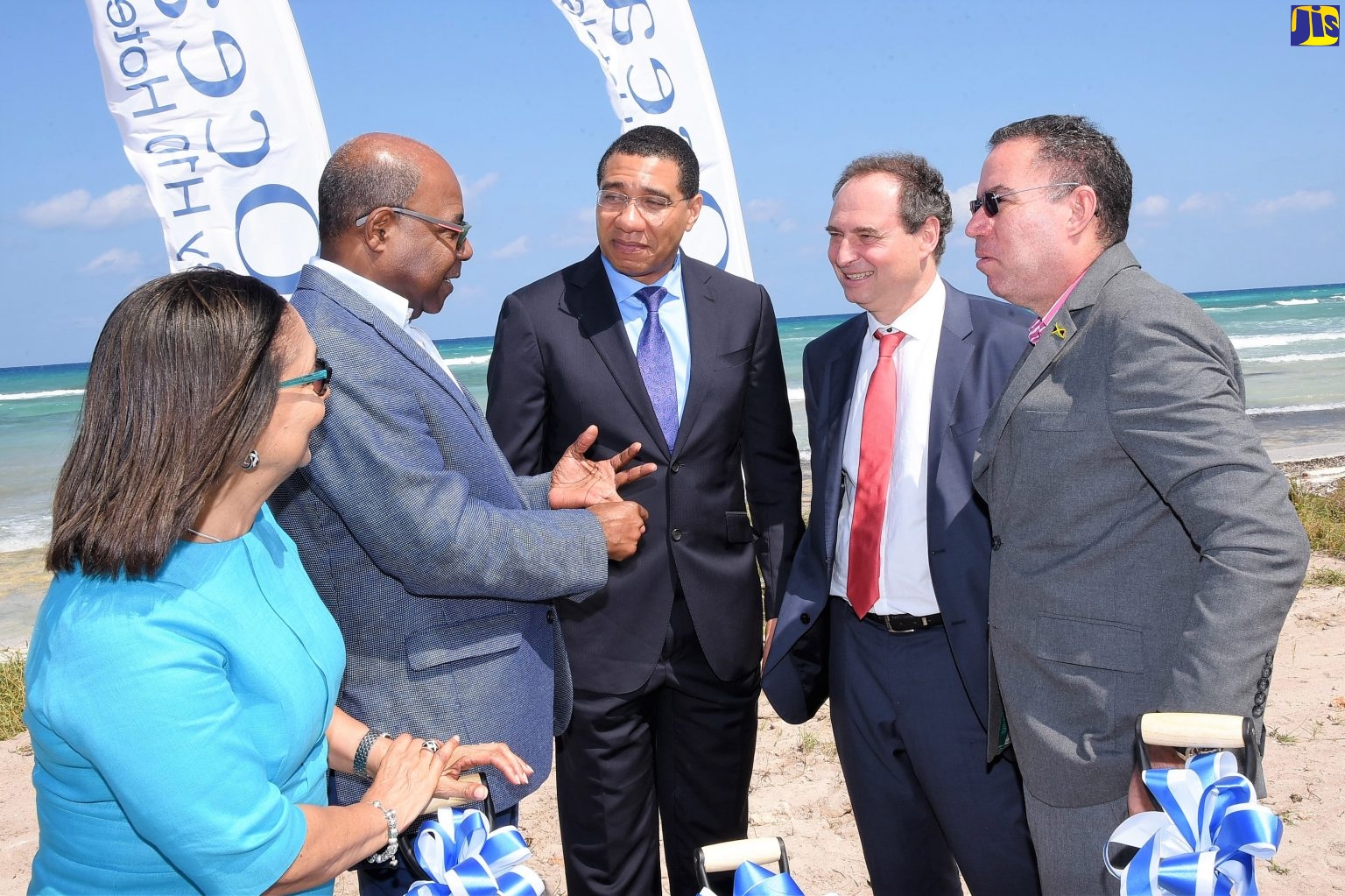  Prime Minister, the Most Hon. Andrew Holness (third left), listens to Minister of Tourism, Hon. Edmund Bartlett (second left),  at the official ceremony to break ground  for the new Ocean Coral Spring Hotel in Trelawny, on February 6. Also listening (from left) are Minister of Labour and Social Security, Hon. Shahine Robinson; Director of International Division, H10 Hotels, Antonio Hernandez;  and Minister without Portfolio, Ministry of Economic Growth and Job Creation, Hon. Daryl Vaz. 