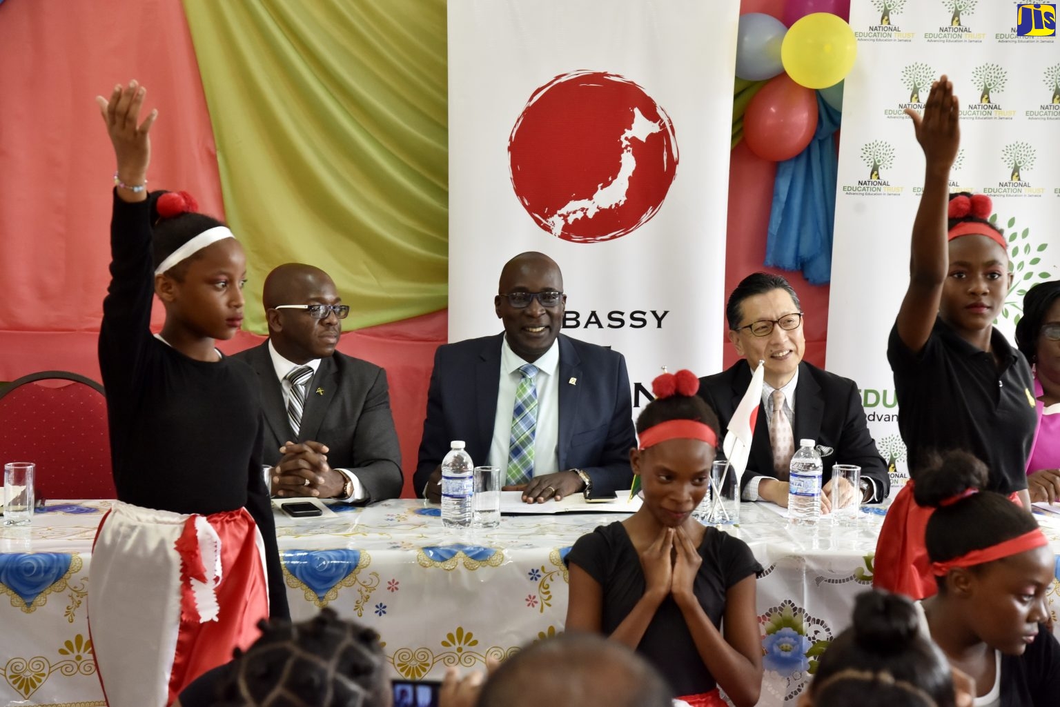 Minister of Education, Youth and Information, Senator the Hon. Ruel Reid (centre); State Minister in the Ministry of Foreign Affairs and Foreign Trade, Senator the Hon. Pearnel Charles Jr. (left), and Japanese Ambassador to Jamaica, His Excellency, Hiromasa Yamazaki, observe the performance of students of the Rock River Primary School, at the recent official opening of a learning centre at the Clarendon-based institution.