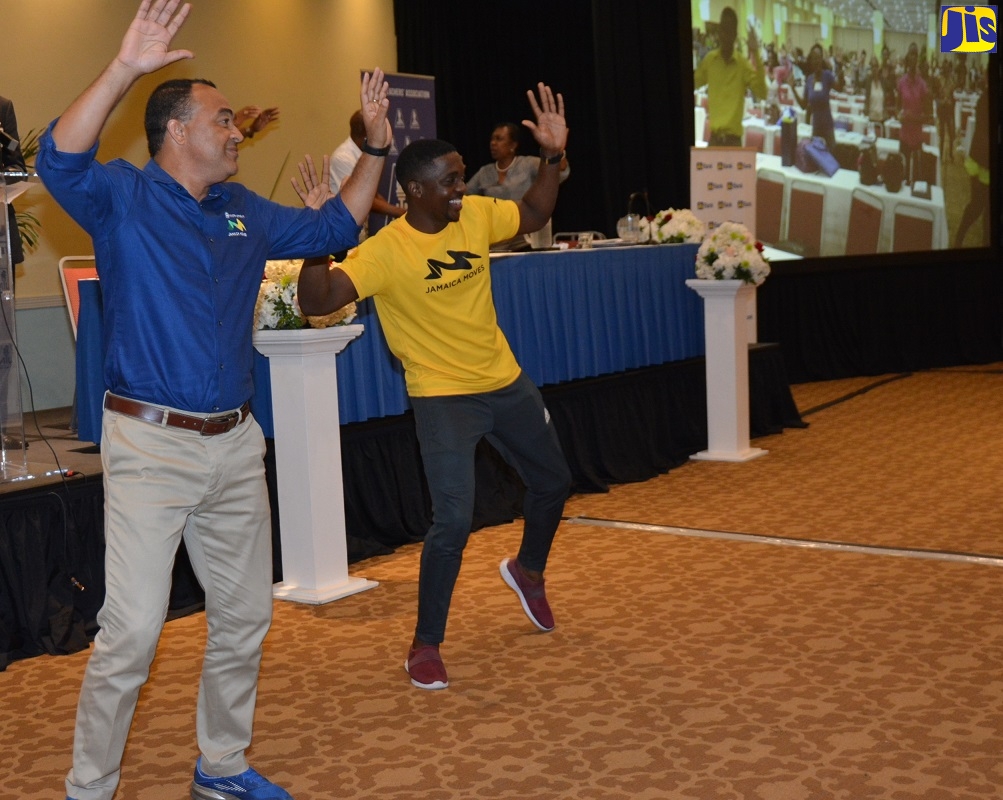 Minister of Health, Dr. the Hon. Christopher Tufton (left) engages in a workout session with fitness instructor, Raymond White (right), at the Jamaica Teachers’ Association (JTA) 18th Annual Education Conference on Thursday (April 25), at the Hilton Rose Hall Resort and Spa in St. James.