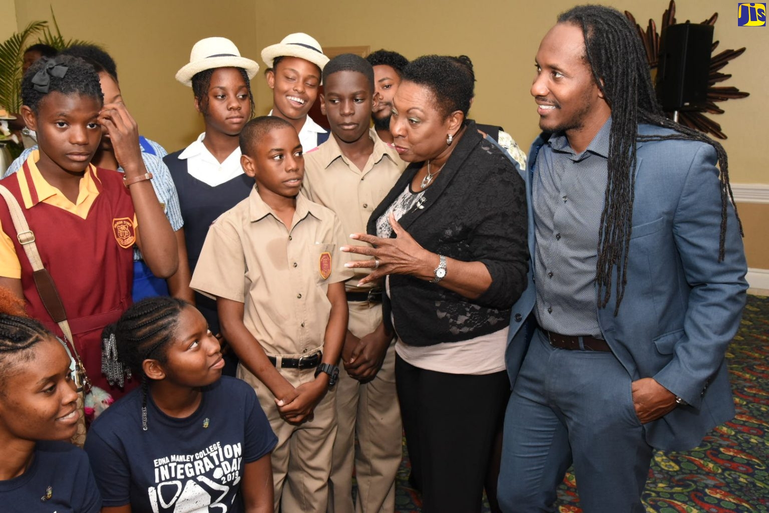 Minister of Culture, Gender, Entertainment and Sport, Hon. Olivia Grange (second right), and Minister of State in the Ministry of Education, Youth and Information, Hon. Alando Terrelonge (right), interact with students at the launch of the Gender Ambassadors Programme (GAP), at The Knutsford Court Hotel in New Kingston.