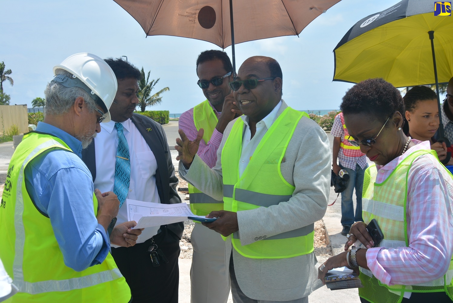 Minister of Tourism, Hon. Edmund Bartlett (second right), speaking with the development team for the Hampden Wharf Development Project, during a tour of the projec site in Falmouth, Trelawny, recently. From left are: Architect at Apec Consultants Ltd, Christopher Shaw;  Director of Project at the Tourism Enhancement Fund (TEF), Johan Rampair; Executive Director of the TEF, Dr. Carey Wallace; and Director of Craft Development Institute in Falmouth, Carol Rose-Brown.