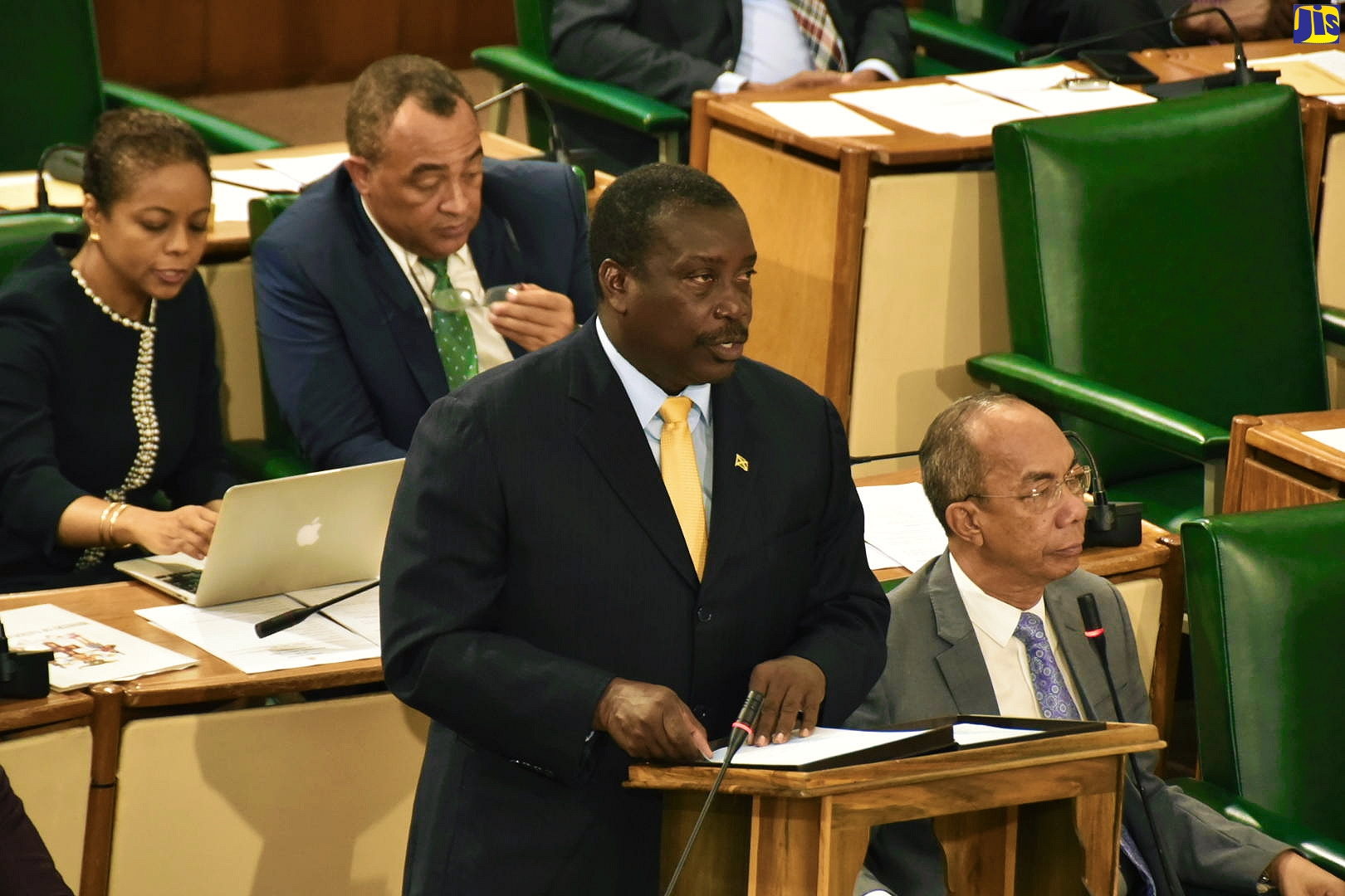Minister of Transport and Mining, Hon. Robert Montague (left) making his contribution in the 2019/20 Sectoral Debate in the House of Representatives on Tuesday, June 4. Seated (at right) is Minister of National Security, Hon. Dr. Horace Chang, while in the background are Attorney General, Marlene Malahoo Forte; and Minister of Health and Wellness, Dr. the Hon. Christopher Tufton.