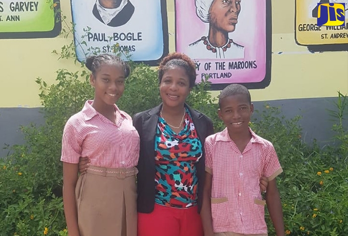 Principal of Mount Airy Primary  and Infant School, Karen Anderson-McFarlane (centre), is flanked by the school’s top-performing students in the Primary Exit Profile (PEP),   Andrea Barnes (left) and  Tian Raye Barnes . 