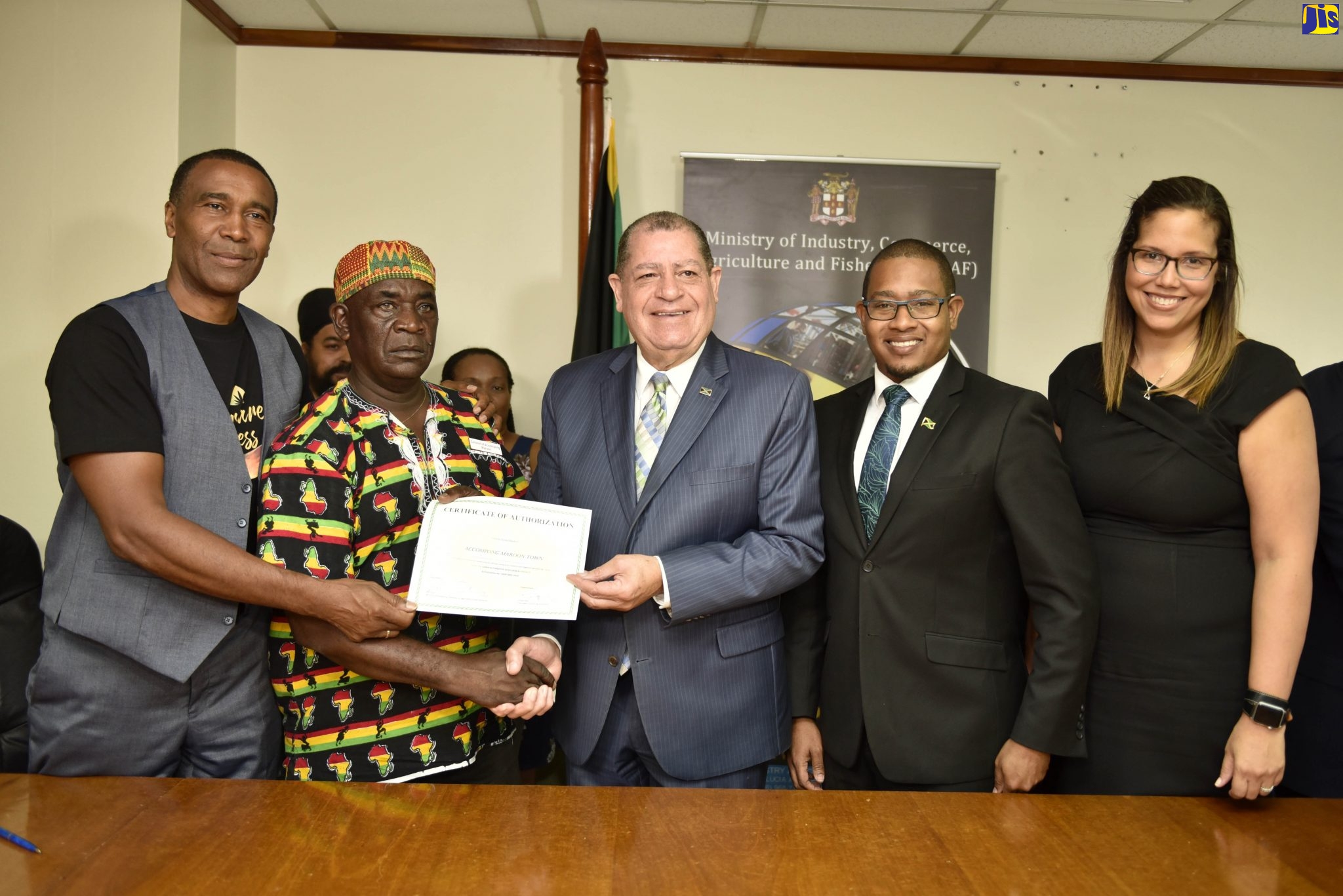 Minister of Industry, Commerce, Agriculture and Fisheries, Hon. Audley Shaw (centre); Colonel of the Accompong Town Maroons, Ferron Williams (second left); and President and Chief Executive Officer, Timeless Herbal Care, Courtney Betty (left), display a certificate of authorisation, at the signing of a tripartite agreement for a cannabis pilot programme in Accompong St. Elizabeth, under the Alternative Development Project. The signing ceremony took place at the Ministry’s New Kingston offices on Monday (July 8). Sharing the moment are State Minister for Industry, Commerce, Agriculture and Fisheries, Hon. Floyd Green (second right); and Chairman, Cannabis Licensing Authority, Hyacinth Lightbourne.