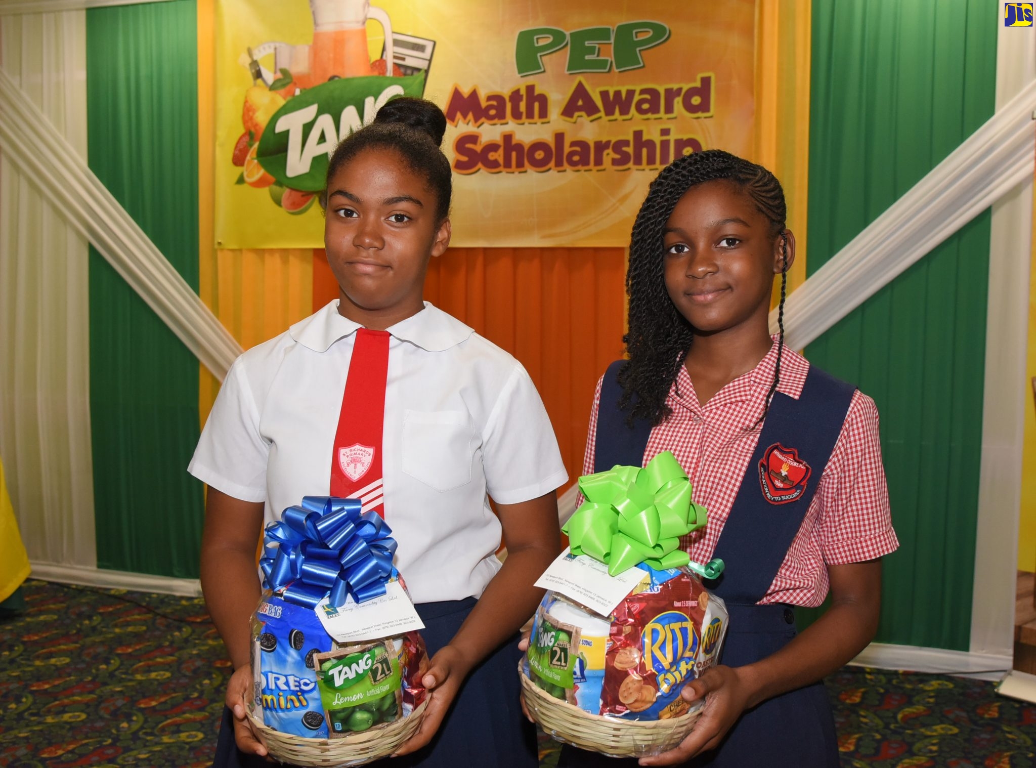 TANG Primary Exit Profile (PEP) scholarship awardees, Gabrielle Nelson (left) and Zoé Hume show off their prizes during the TANG Primary Exit Profile awards luncheon, held at The Knutsford Court Hotel in New Kingston, on July 30.