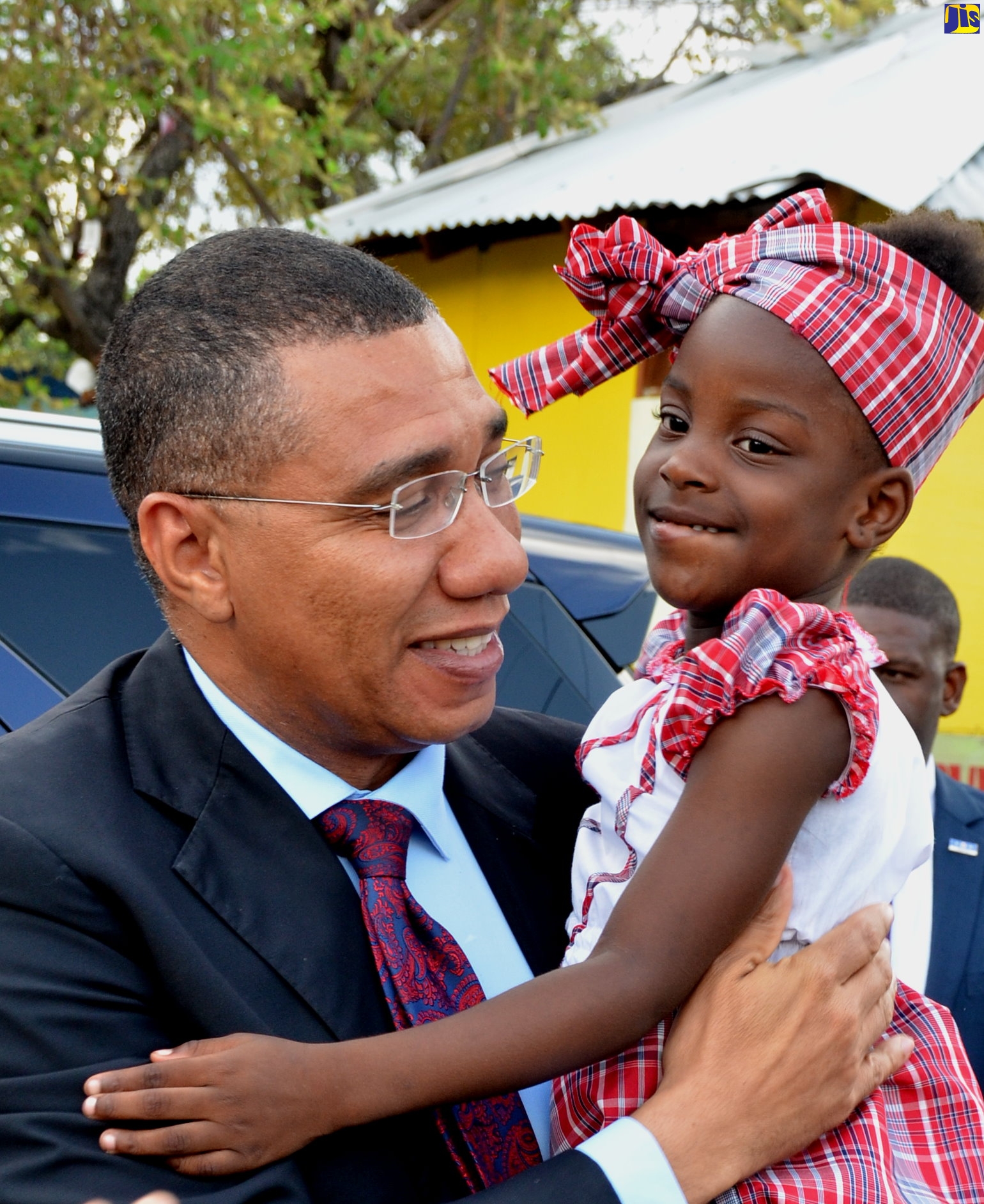 Prime Minister, the Most Hon. Andrew Holness (left), engages with Seaward Primary and Junior High School student, Kerica Thomas. Occasion was a ceremony to officially open a play area and honour stakeholders, held at the insitution on Olympic Way, St. Andrew, on July 25.