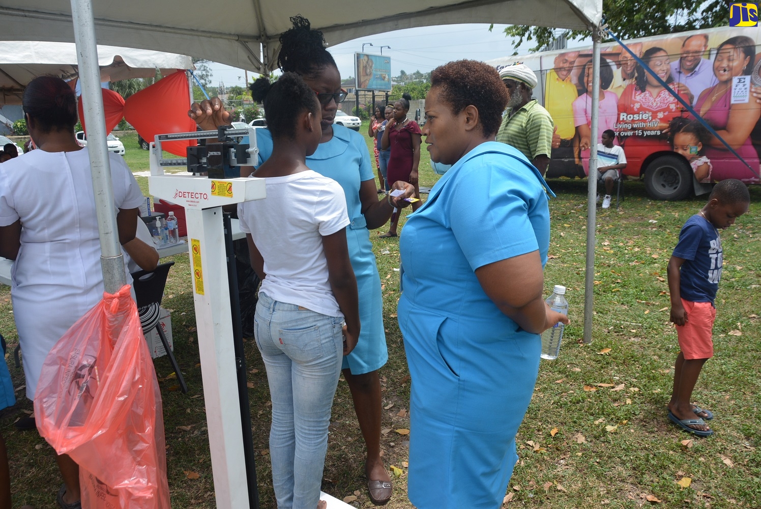 A student having her weight checked by Community Health Aides, Latoya Murray (left) and Ardett Vernon, during the St. James Public Health Services staging of the second annual ‘Food Safety and Back-to-School Fair’, held at Pier One in Montego Bay on Friday, August 16.