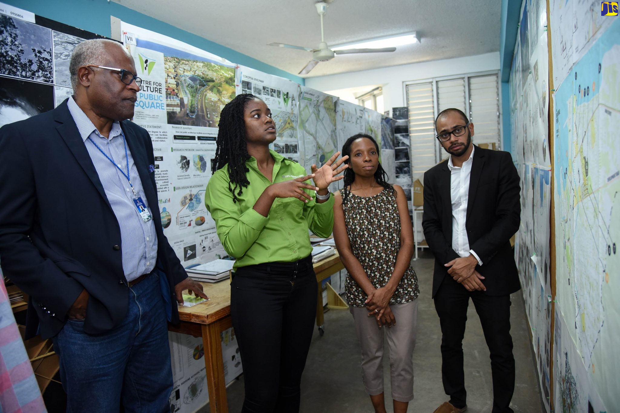 Project Manager for the Vernamfield Development, Lieutenant Colonel Oscar Derby (left), listens keenly as Sana Williams (second left), Master of Architecture student at the University of Technology (UTech) Caribbean School of Architecture (CSA), explains her final-year project. Also pictured (from third left) are Master of Architecture Programme Director, CSA, Mlela Matandara-Clarke; and Programme Director, Bachelor of Arts Architectural Studies, CSA, André Baugh. Occasion was a visit by the Core Implementation Team of the Vernamfield Development project to the school during its 30th anniversary exhibition.