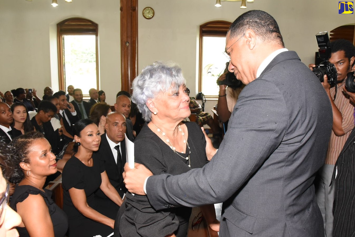 Prime Minister The Most Hon. Andrew Holness, comforts Vilma Baugh (widow) at the funeral of late Deputy Prime Minister, Dr. Kenneth Baugh, OJ on Thursday (September 19)