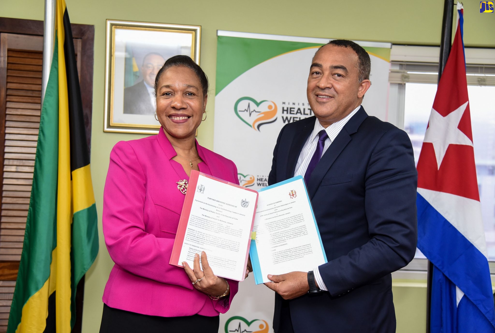 Minister of Health and Wellness, Dr. the Hon. Christopher Tufton (right), and Cuban Ambassador to Jamaica, Her Excellency Inés Fors Fernández, display the signed agreement to expand the Jamaica-Cuba Eye Care Programme, at a ceremony held today (September 24), at the Ministry in New Kingston.