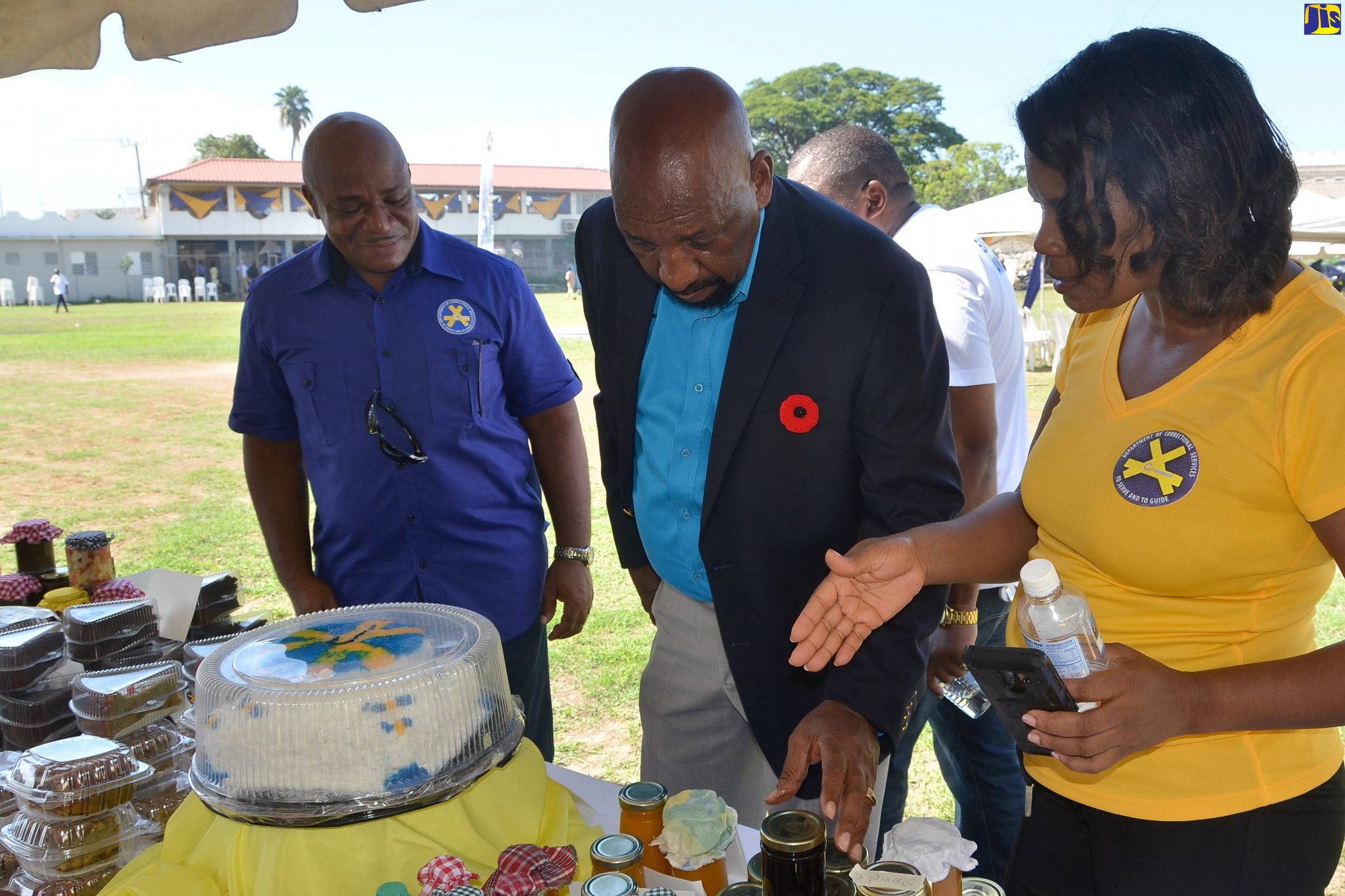 Minister of State in the Ministry of National Security, Hon. Rudyard Spencer (centre), examines products being shown to him by Director, Juvenile Services, Department of Correctional Services,  Claudeth Hamilton, at the Department of Correctional Services