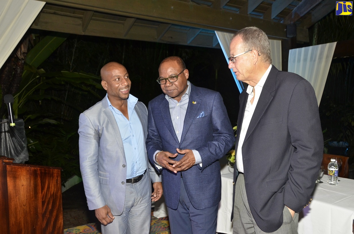 Tourism Minister, Hon. Edmund Bartlett (centre), in discussions with Jamaica Hotel and Tourist Association (JHTA) President, Omar Robinson (left), and Managing Director of Sunset at the Palms Resort, Ian Kerr, during the hotel’s 15th anniversary ceremony in Negril, Westmoreland, on Sunday (October 13).