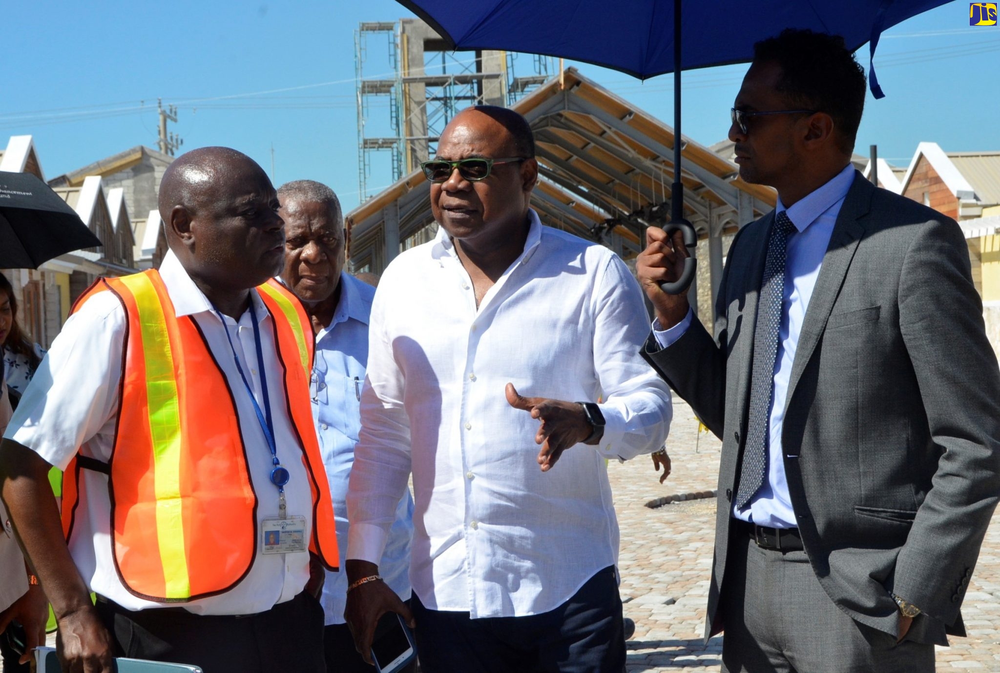 Minister of Tourism, Hon. Edmund Bartlett (second right), converses with (from left): Senior Vice President of Engineering and Port Development at the Port Authority of Jamaica (PAJ), Mervis Edghill; Chairman of the Tourism Enhancement Fund (TEF), Godfrey Dyer; and Executive Director of the TEF, Dr. Carey Wallace, during a tour of the Hampden Wharf Artisan Village site in Falmouth, Trelawny, on Tuesday (October 29).